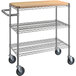 A chrome utility cart with three shelves, wheels, and a wooden top.