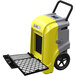 An AlorAir yellow and grey commercial dehumidifier with a black handle and wheels.