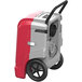 An AlorAir red and grey commercial dehumidifier with wheels.