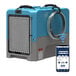 An AlorAir industrial dehumidifier in a blue and grey box with a wire wrapped around it.
