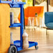 A blue cart with a Lavex lambswool duster on it with a black handle.