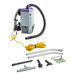 A ProTeam backpack vacuum with accessories including a hose and tools.