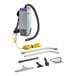 A ProTeam backpack vacuum with a hose and accessories.