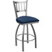 A stainless steel Holland Bar Stool with a blue cushioned swivel seat.