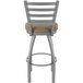 A Holland Bar Stool outdoor extra tall bar stool with a beige cushion on the seat and backrest.