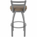 A Holland Bar Stool stainless steel outdoor bar stool with a tan cushioned seat.
