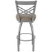 A Holland Bar Stool stainless steel outdoor counter stool with a tan cushion.