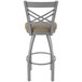 A Holland Bar Stool stainless steel outdoor bar stool with a tan cushion on the seat.