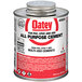 A can of Oatey all purpose cement with a white label