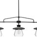An oil-rubbed bronze pendant light fixture with three clear glass shades.