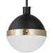 A Globe matte black and brass pendant light with a white glass shade.