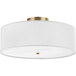 A Globe white linen and matte brass flush mount light with a white shade.