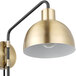 A Globe Antique Brass wall sconce with a light bulb.