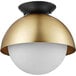 A Globe matte brass and black ceiling light fixture with a gold shade.