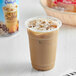 A close-up of a cup of International Delight Caramel Macchiato Iced Coffee.