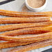A group of McCormick Culinary Cinnamon Sugar churros on a white surface.