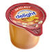 A close up of a plastic container of International Delight Hazelnut Non-Dairy Creamer.