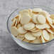 A bowl of Republica del Cacao white chocolate couverture chips.