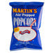 A blue and white bag of Martin's air popped butter flavored popcorn.