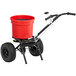 A red bucket on a black Chapin Contractor Turf Spreader.