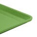 A lime green Cambro dietary tray with a black bottom.
