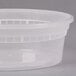 A close-up of a Pactiv translucent plastic deli container with a lid.