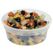 A Pactiv translucent plastic deli container filled with mixed vegetables.