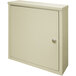 A beige metal Omnimed wall-mount storage cabinet with a key lock.