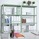 A light green AR Shelving metal shelving unit with binders and a potted plant on it.