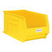 A yellow plastic bin with a white label holder on it.