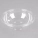 A clear plastic Fineline bowl on a white surface.