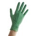 A hand wearing a green Showa biodegradable nitrile glove.