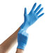 A person wearing blue Showa nitrile gloves.