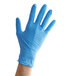 A hand wearing a blue Showa nitrile glove.