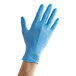 A hand wearing a blue Showa biodegradable nitrile glove.