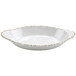 A white oval melamine side dish with brown specks.