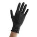A hand wearing a black Showa biodegradable nitrile glove.