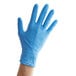 A hand wearing a Showa blue nitrile glove.