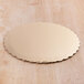 An 18" gold laminated corrugated cake circle on a wood surface.