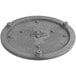 A grey round cast iron hot plate with holes.