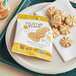 A plate of Homefree lemon burst cookies with a package of cookies on the table.