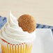 A cupcake with Homefree Gluten-Free Organic Mini Ginger Snap Cookie on top.