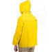 A person wearing a yellow Cordova rain jacket.