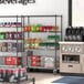 A Steelton wire shelving kit with casters and shelves holding beverages.