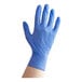 A hand wearing a blue Noble NexGen nitrile glove.