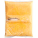 A plastic pouch of golden yellow cheese sauce.
