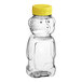 An 8 oz. clear plastic bear bottle with a yellow lid.