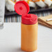 A 5.5 oz. clear PET plastic sauce bottle with a red lid.