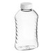 A clear ribbed PET plastic honey bottle with a white flip top lid.