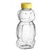 A 16 oz. clear plastic bear bottle with a yellow cap.